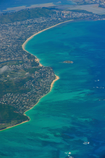 View of a tropical beach and ocean from an airplane