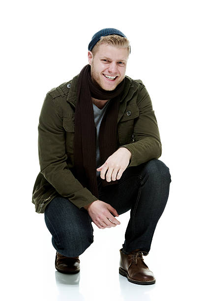 istock Smiling casual man kneeling and looking at camera 476031808
