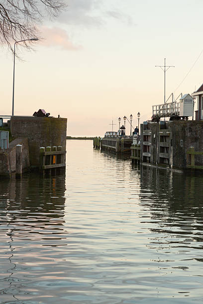 istock Dutch harbour entrance at sunset. 476031813