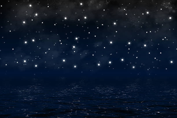 istock background with night sky over ocean, nebula and shiny stars 476031938