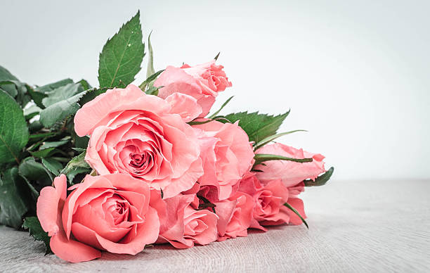Wonderful pink roses on wooden table stock photo