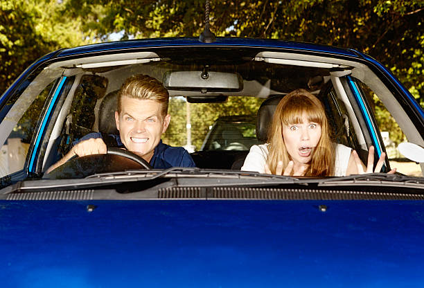 istock Road rage! Aggressive young male driver with terrified female passenger 476033831