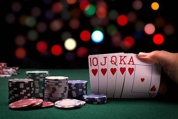 Poker Hand A close up view of a poker hand , at a card table, with a colorful blurred background hand of cards stock pictures, royalty-free photos & images