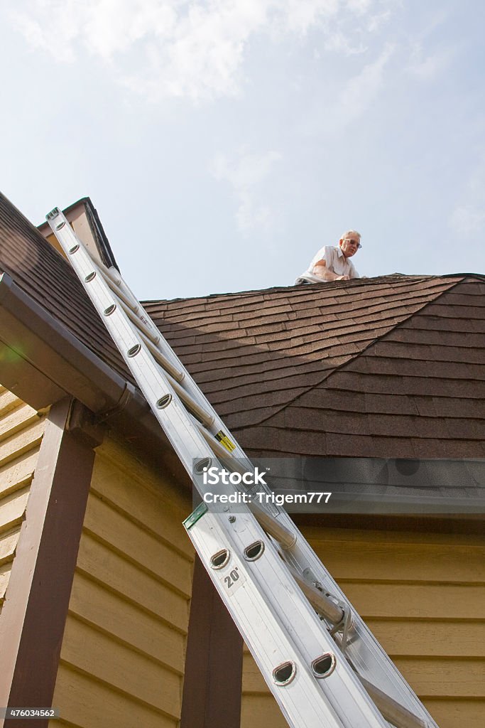 roof inspector Roof inspector check for damage after recent wind storms, many roofs were damaged Damaged Stock Photo