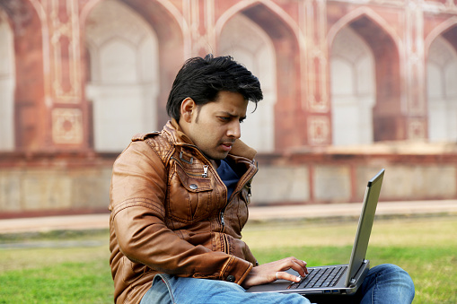 Young Men Using Laptop Outdoor Portrait.