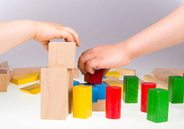 istock Child's hand and building blocks 476037226