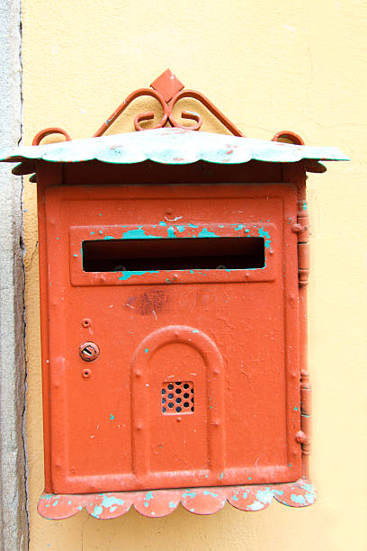 istock Cute Bright Orange Vintage Mailbox on Yellow Wall, Tuscany 476037264