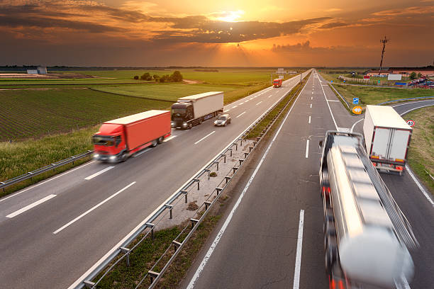 istock Driving trucks in motion blur on the highway at sunset 476037634