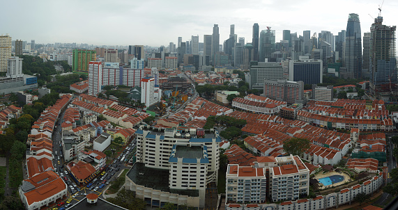 A aerial hi-res photo of Singapore China Town with its unique rows of shop houses and the city area tall builings as back drop.