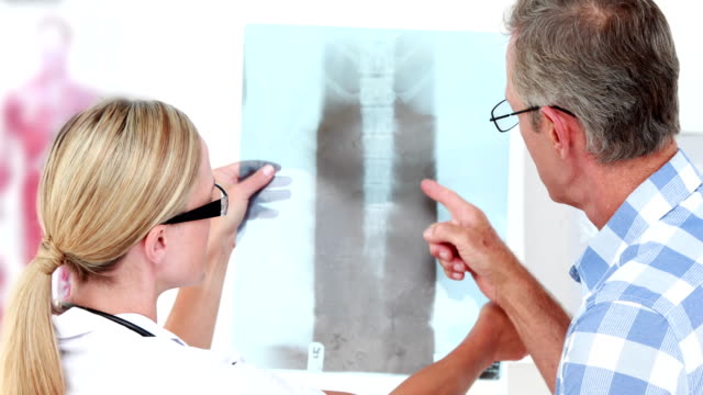 Doctor showing Xrays to her patient