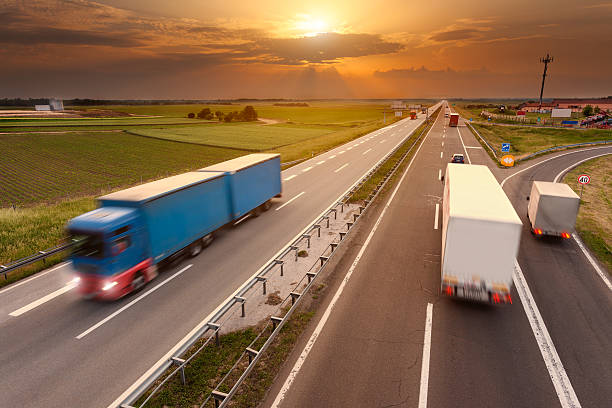 istock Many trucks in motion blur on the highway at sunset 476039788