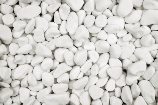 Close up of white stones, pebbles background, texture with copy space