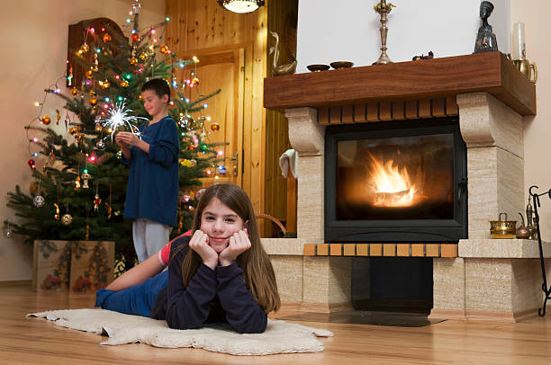 istock Two kid front of fireplace at Christmas 476040973