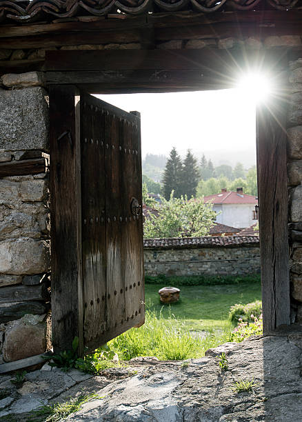istock Open old woood door with panorama view 476045214