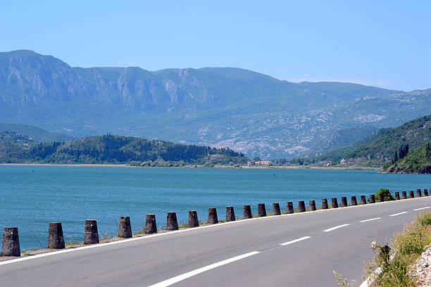 istock highway beside lake landscape 476049194