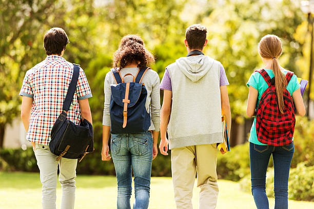 istock Rear View Of Students Walking On Campus 476062731