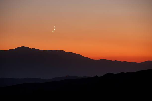 Moonset over California mountains stock photo