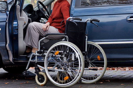 Elder disabled person driving a car