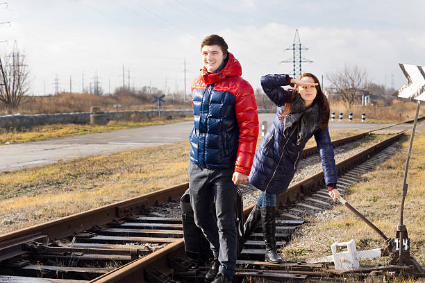 istock Playful couple waiting for a train with luggage 476065745