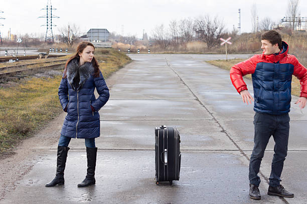 istock Young couple standing arguing in the road 476065823