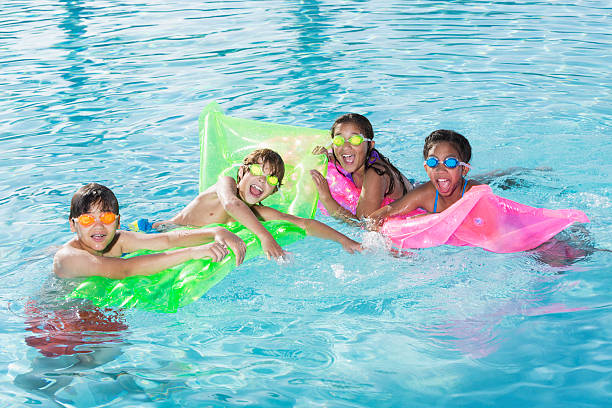 istock Group of kids in swimming pool 476072951