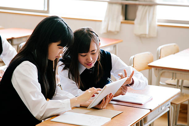 istock High school girls, using tablet computer, in a classroom, Japan 476081338