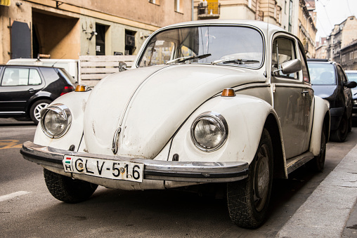 Budapest, Hungary - February 22, 2015: A rusty Volkswagen Beetle parked in a street of Budapest, the hungarian capital