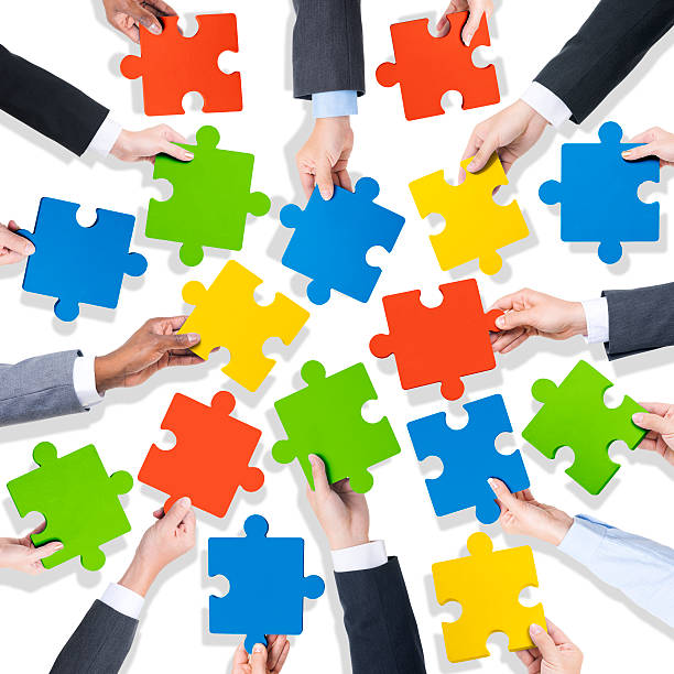 istock Group of Hands Holding Jigsaw Pieces 476083942