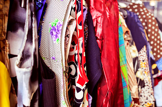 istock clothes hanging on a rack in a flea market 476083994