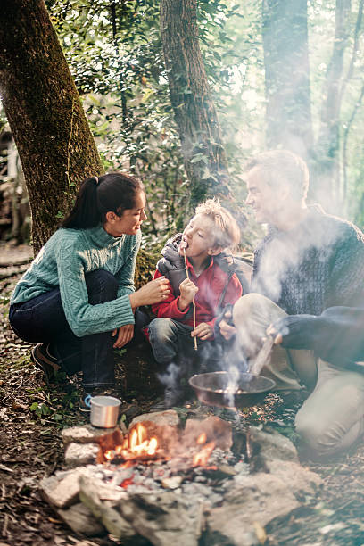 istock cheerful family roasting marshmallows 476084166