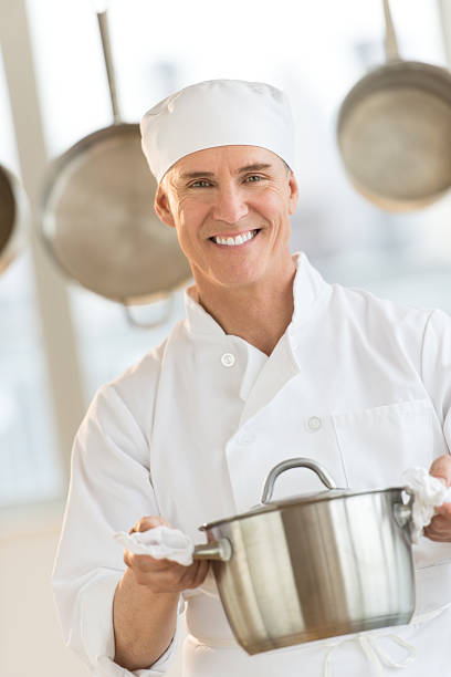 istock Happy Chef Holding Utensil In Commercial Kitchen 476084247