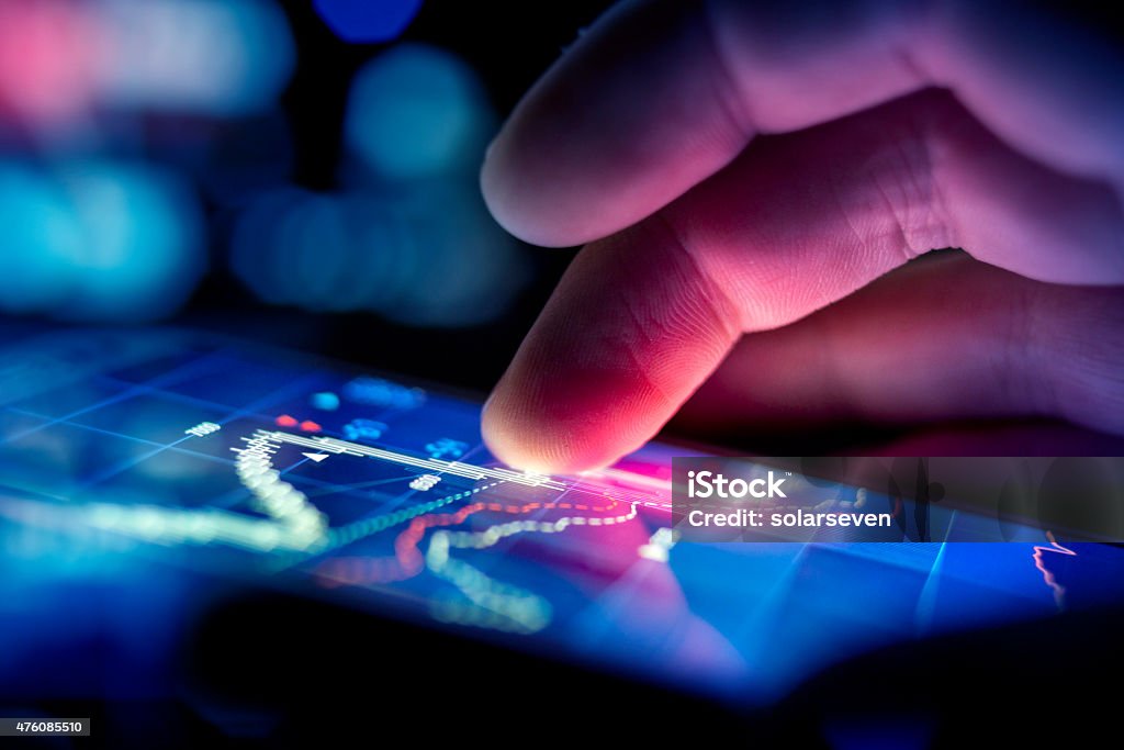Businessman Checking Data A city businessman using a mobile device to check stocks and market data. Close up shot. Technology Stock Photo