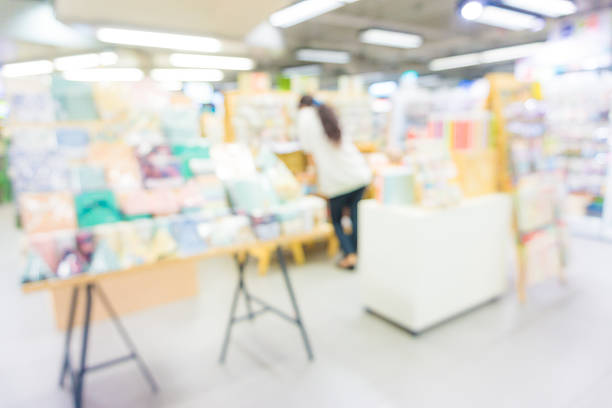 istock Abstract blurred people walking in book store 476085940