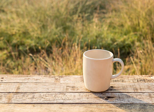 istock White Coffee cup on wooden table at morning sunlight 476088774