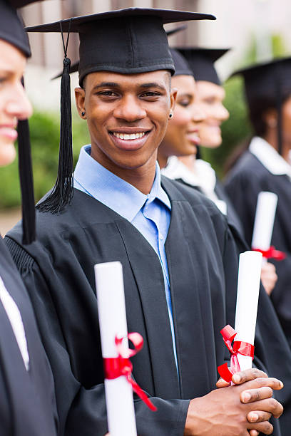 istock african american male graduates standing with classmates 476091469