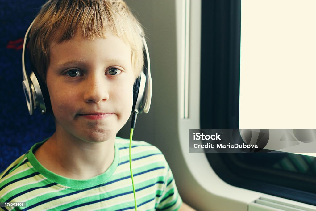 Portrait of cute boy with headphones Portrait of cute boy with headphones traveling in the train Noise Stock Photo