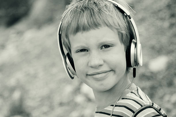 istock Cute autistic boy with headphones 476093618