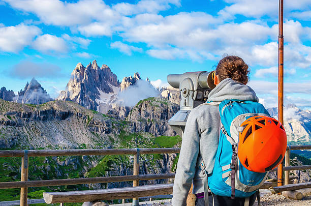 женщина, глядя через бинокль, доломитовые альпы, италия - cortina dampezzo стоковые фото и изображения