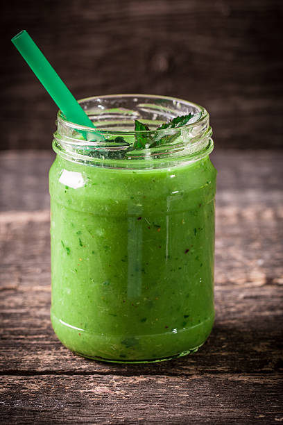 istock green Detox smoothie on wooden table 476094144