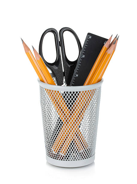 Pencils, ruler and scissors Pencils, ruler and scissors in holder. Isolated on white background yellow scissors stock pictures, royalty-free photos & images