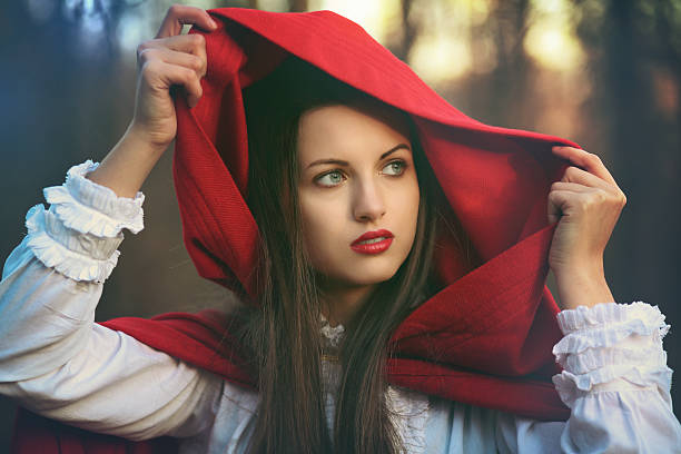 Portrait of a beautiful Little red riding hood  in dark tones