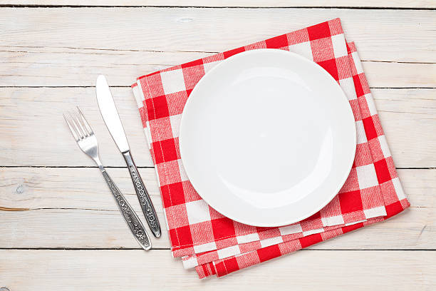 istock Empty plate, silverware and towel over wooden table background 476096772