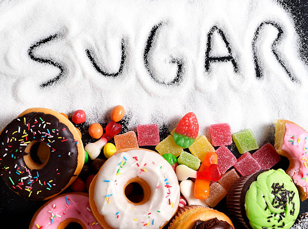 mix of sweet cakes, donuts and candy with sugar text mix of sweet cakes, donuts and candy with sugar spread and written text in unhealthy nutrition, chocolate abuse and addiction concept, body and dental care temptation photos stock pictures, royalty-free photos & images