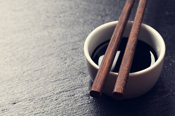 istock Japanese sushi chopsticks over soy sauce bowl 476097576