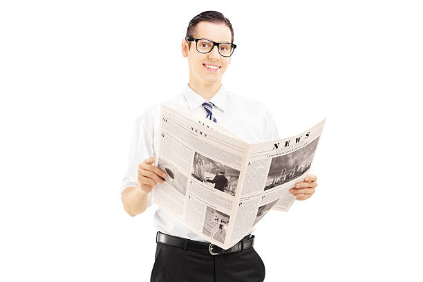 istock Young businessperson standing and reading a newspaper 476097753