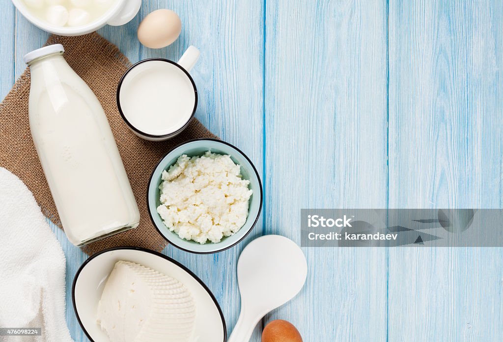 Sour cream, milk, cheese, eggs and yogurt Dairy products on wooden table. Sour cream, milk, cheese, eggs and yogurt. Top view with copy space 2015 Stock Photo