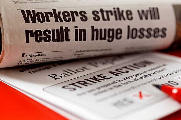 Striking Vote Inspector. News article and Ballot Paper are my graphics. Thanks.     Ballot Paper for vote on industrial action with a worker’s strike with a newspaper article declaring the effect of the anticipated strike action, huge financial losses. strike protest action stock pictures, royalty-free photos & images