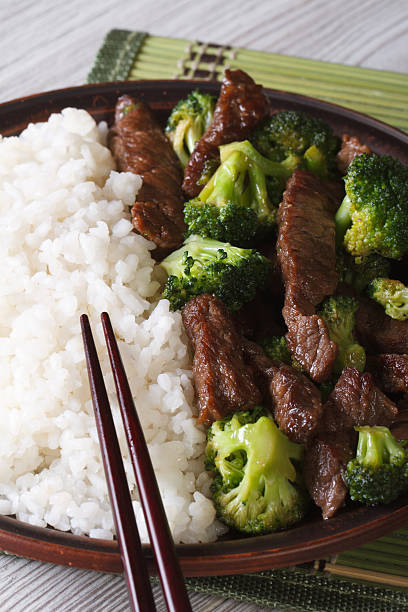 istock Asian beef with broccoli and rice close-up. Vertical 476098628