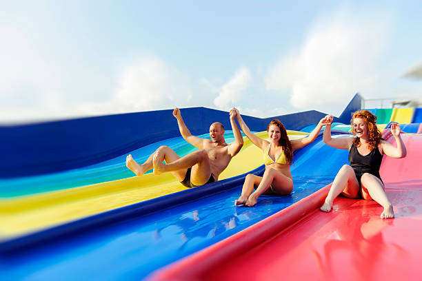 istock friends on water slide 476098837