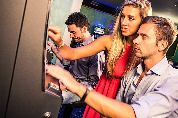istock Young couple gambling on slot machines 476099013